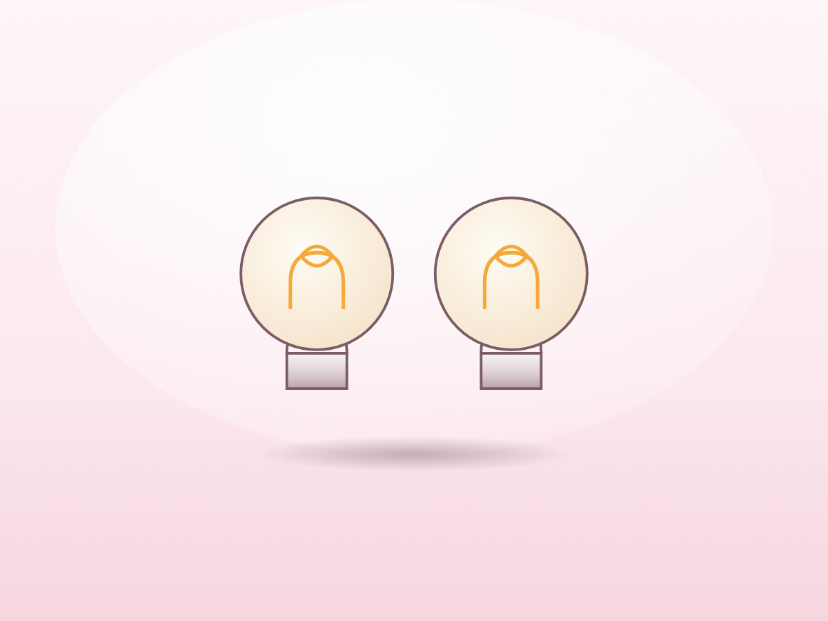 A pair of warm filament bulbs with their visible filaments.